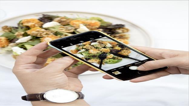 person taking photo of their food with mobile phone