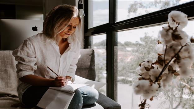 Woman writing in book